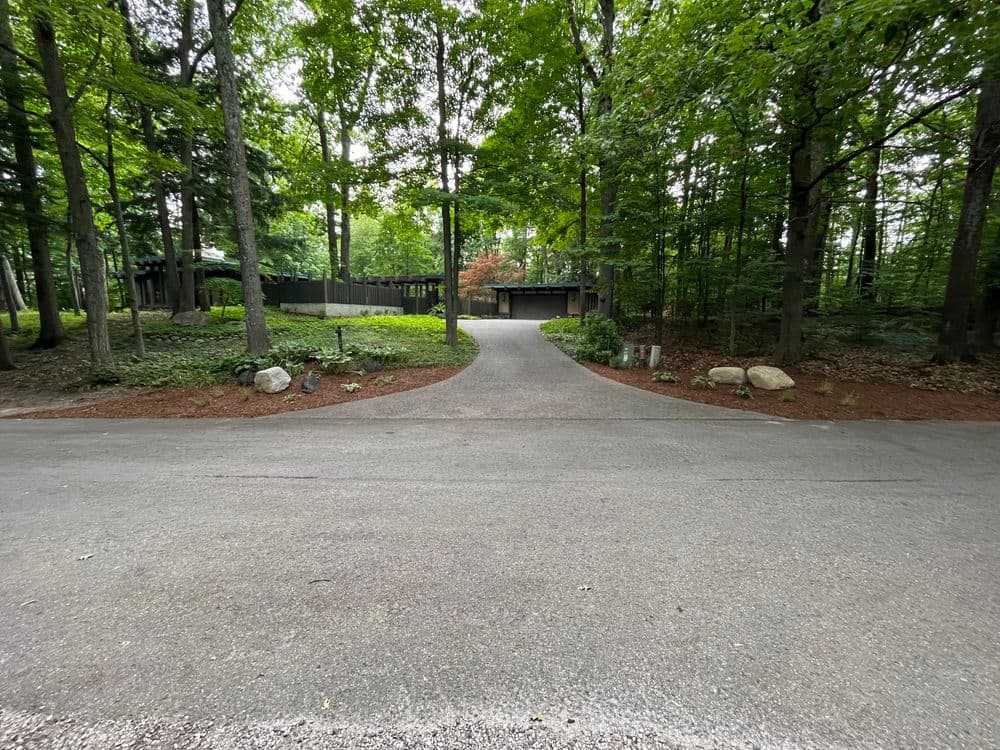 Project Subtle Driveway Entrance Design Using Boulders and Natural Plantings image